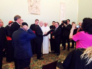 B'nai B'rith International President Allan J. Jacobs (Right) and Executive Vice President Daniel S. Mariaschin (Left) present Pope Francis (Center) with a framed 1965 edition of The Jerusalem Post with coverage on Nostra Aetate