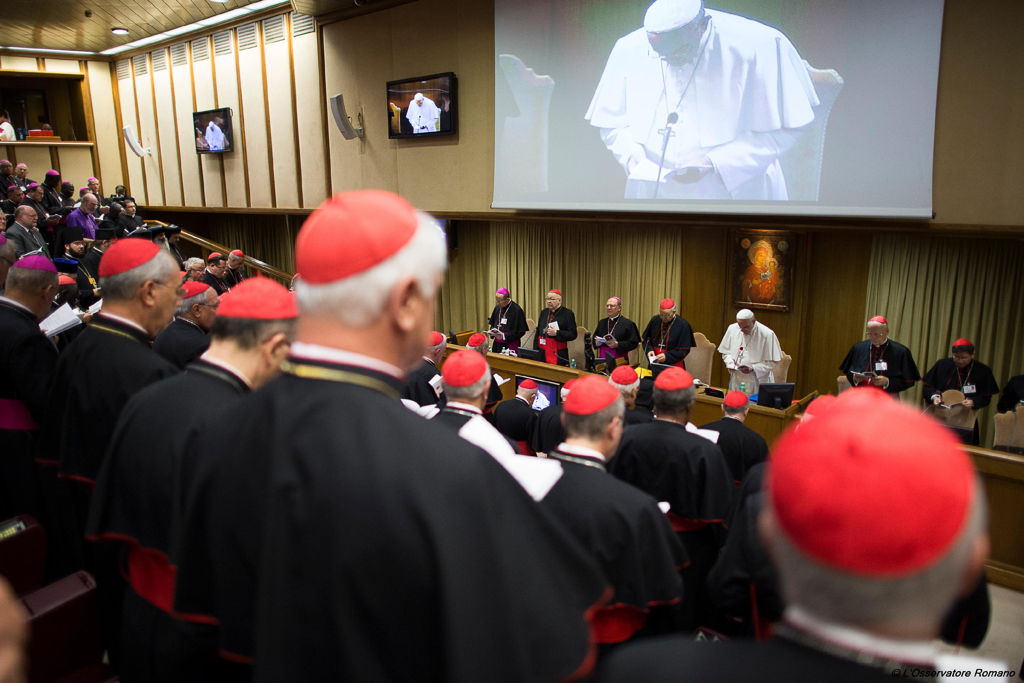 Pope Francis prays at the first session of the Synod of Bishops