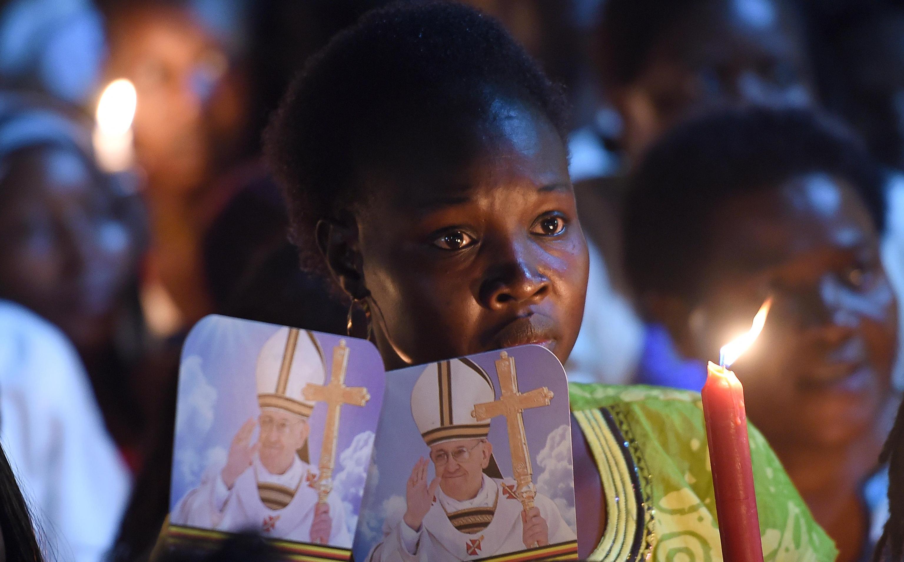 A faithfull waits for the arrival of Pope Francis at the Munyonyo Martyrs' Shrine in the neighborhood of Kampala