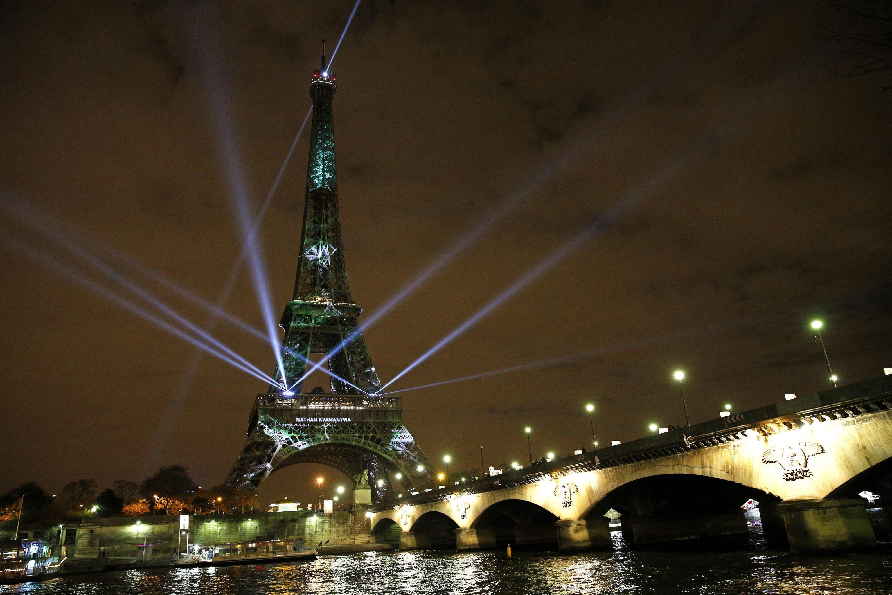 The Eiffel Tower lights up with colors and messages of hope on the eve of the COP21 climate conference in Paris