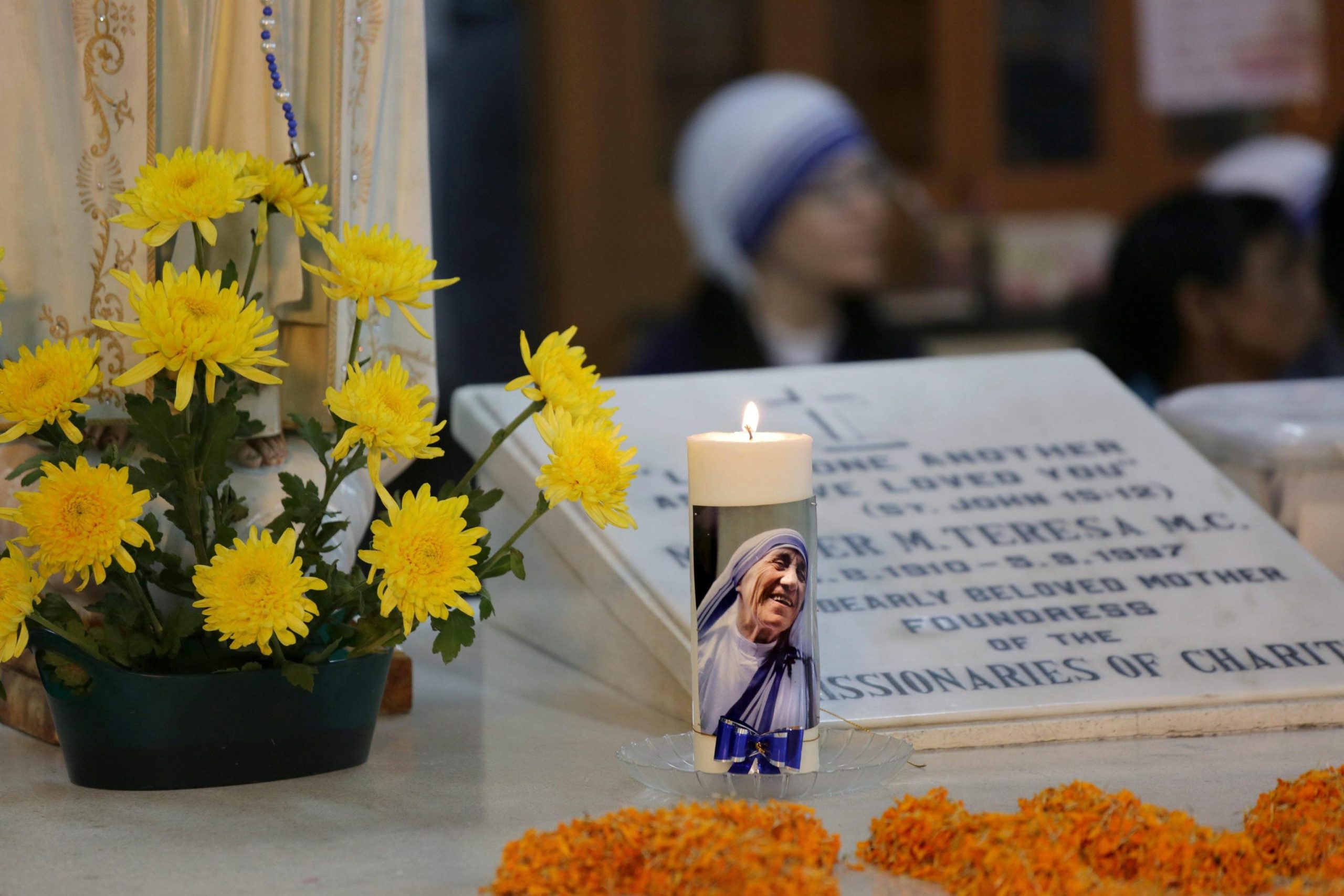 Nuns take part in a mass prayer in front of the Mother Teresa's tomb at Mother House in Calcutta