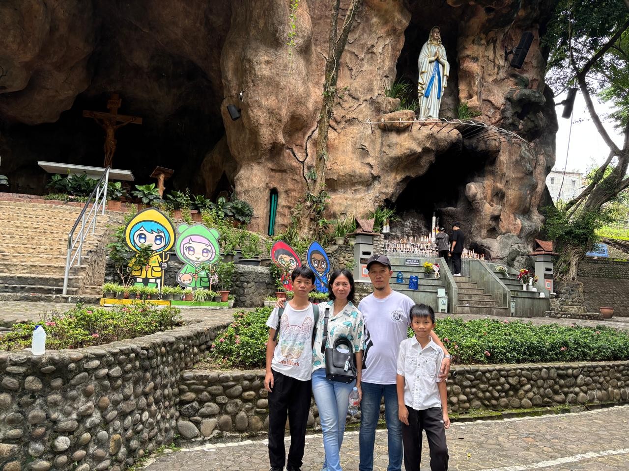 Hendrix Salvatore Chandrawan avec son épouse Fina Vironica Liesabeth et leurs enfants Stefan et Lorenzo, devant une grotte mariale à Surabaya, Indonésie. © Ucanews